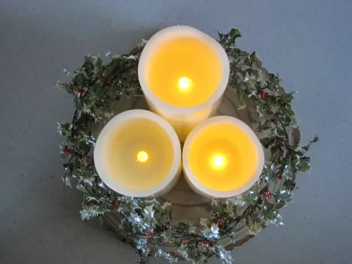 Flickering Candle and Holly display
